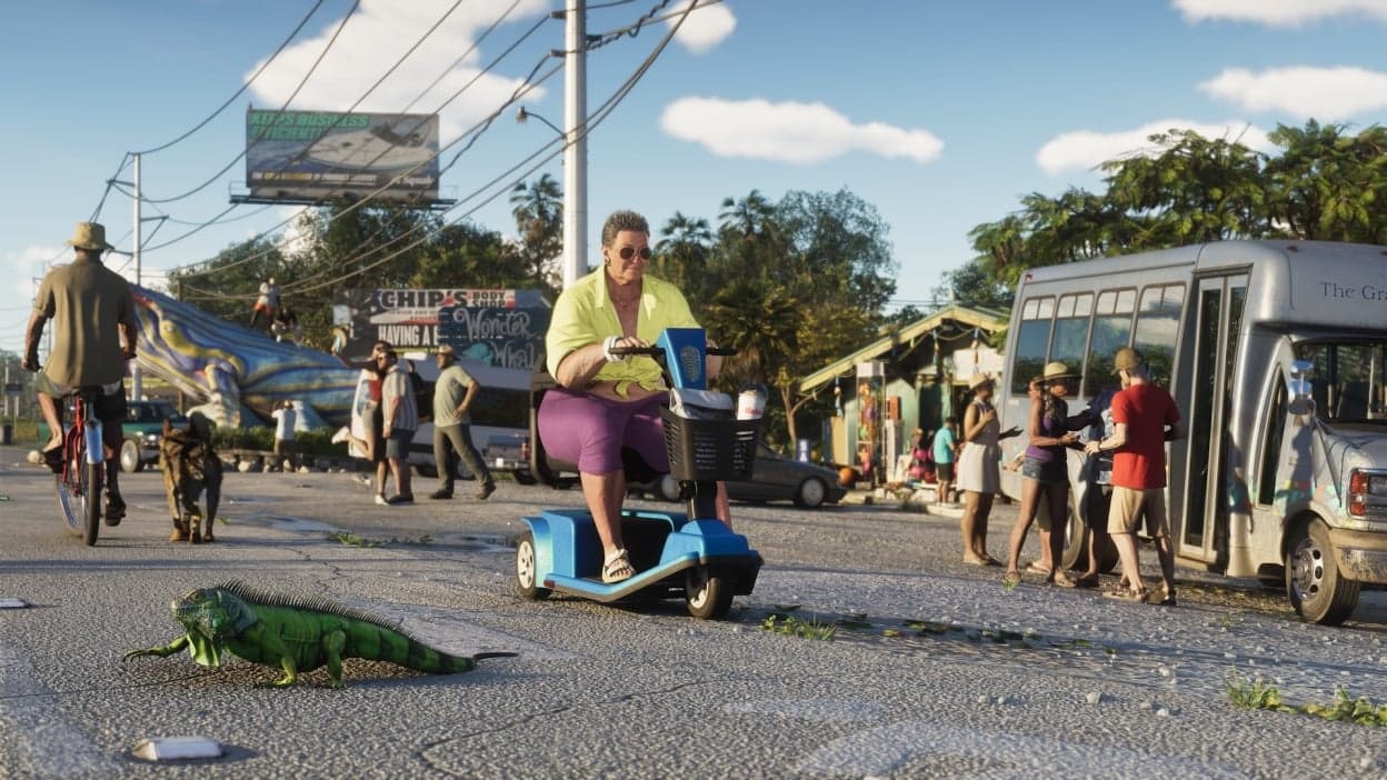 Official Grand Theft Auto VI trailer still of Leonida street life — a woman on a mobility scooter, an iguana on the asphalt, and a tourist shuttle under palm trees